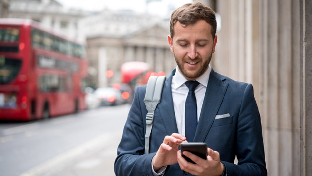 businessman texting on the street