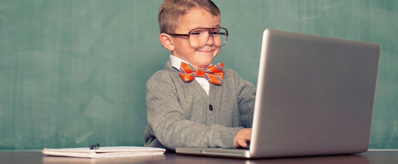 a kid playing with laptop