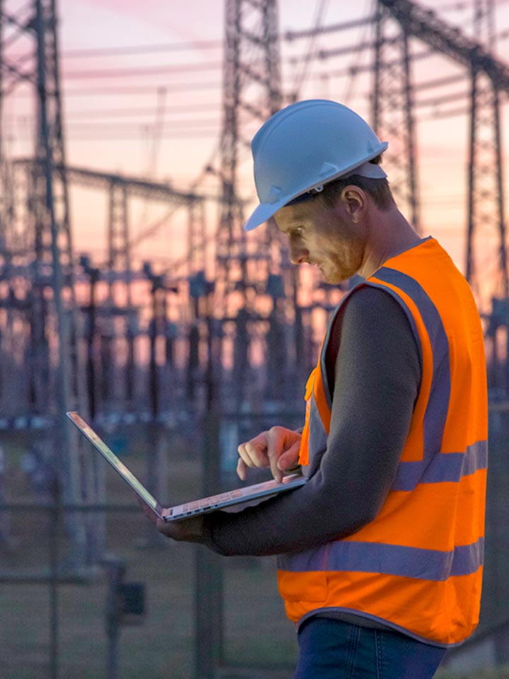 risk engineer looking at laptop 