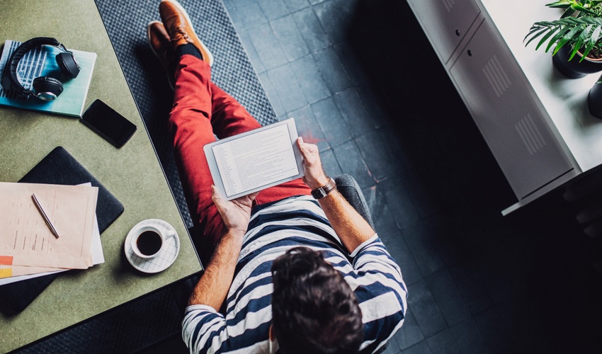 man reading computer tablet