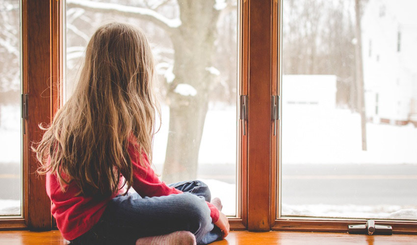 girl watching snow fall