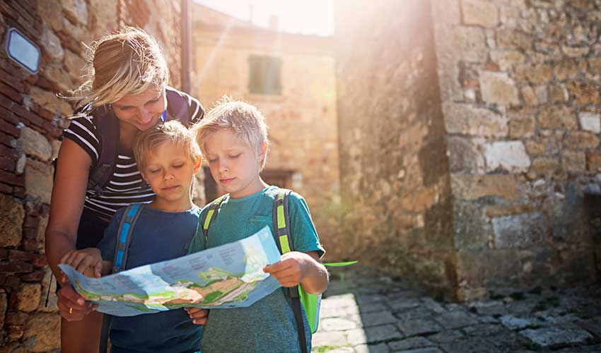 family checking map while travelling