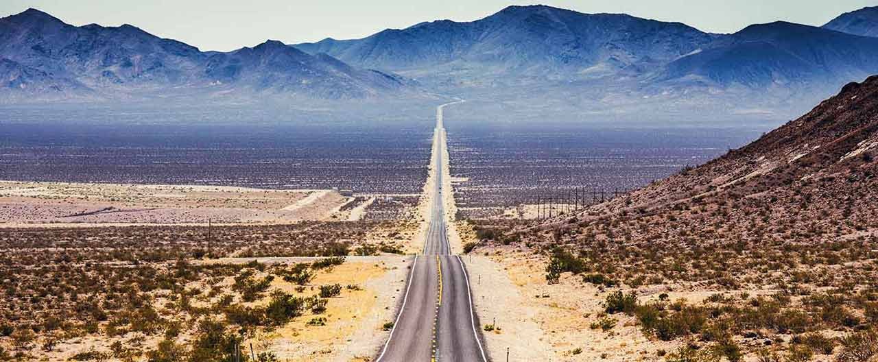 endless straight road with mountain view