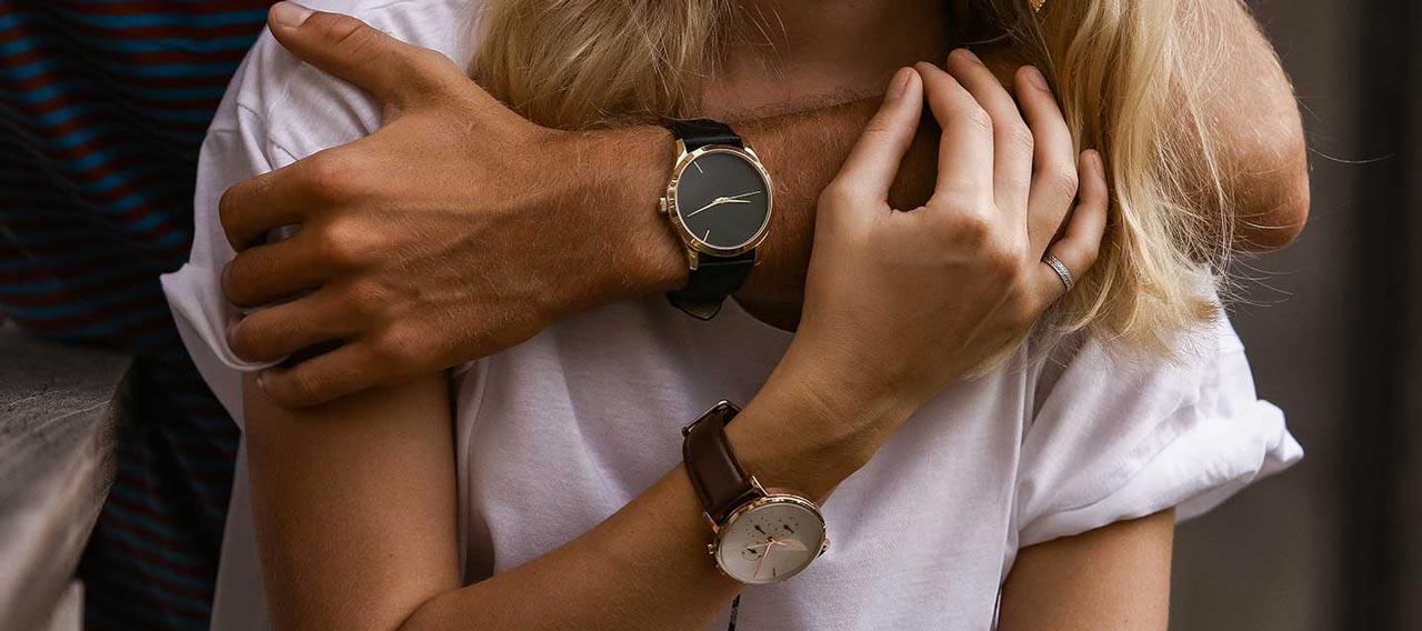 hugging couple with engagement watches