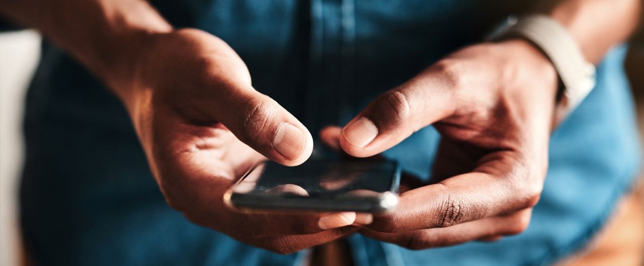 man typing on mobile searching for embedded insurance