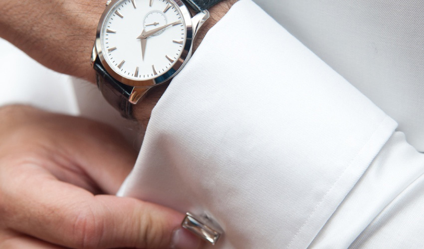 man fixing his cufflink