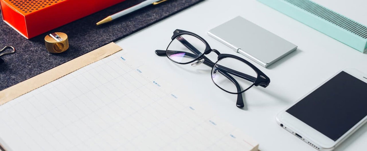 phone notebook and glasses