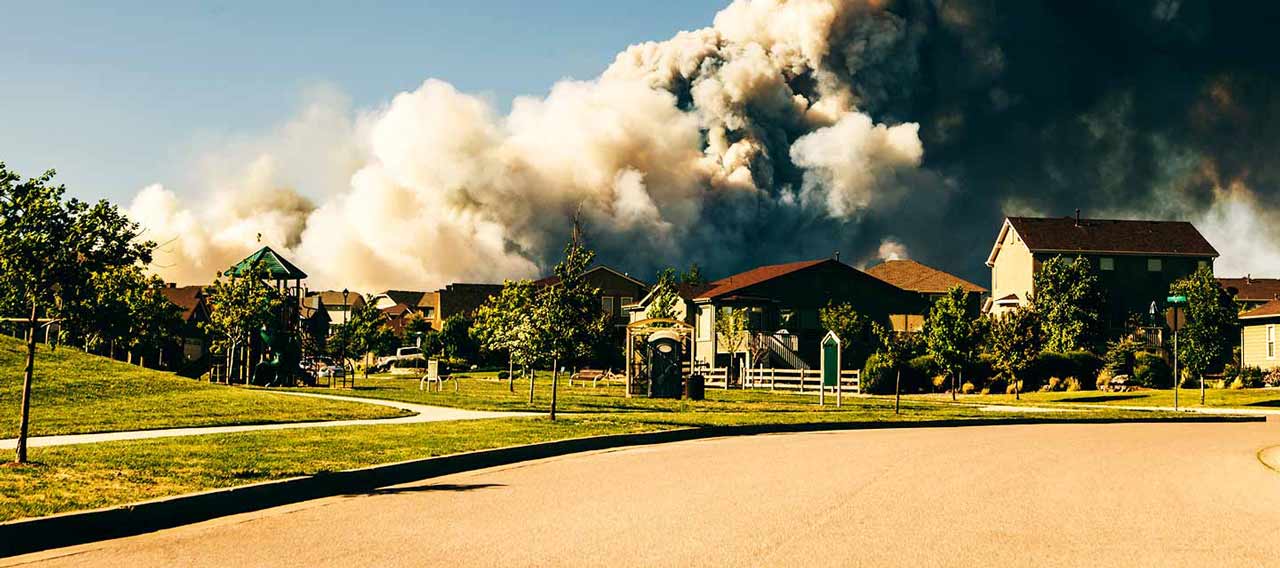 wildfire behind the houses